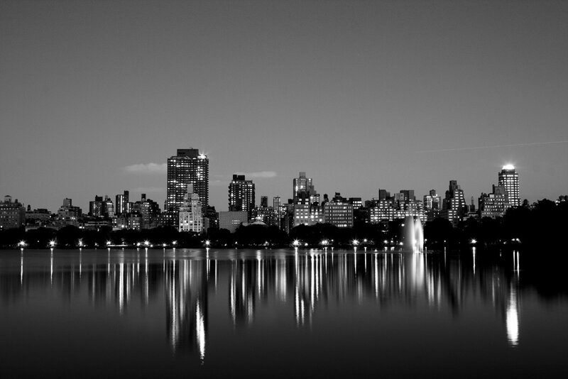 nighttime city skyline by the lake