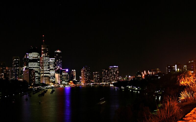 nighttime city skyline by the river