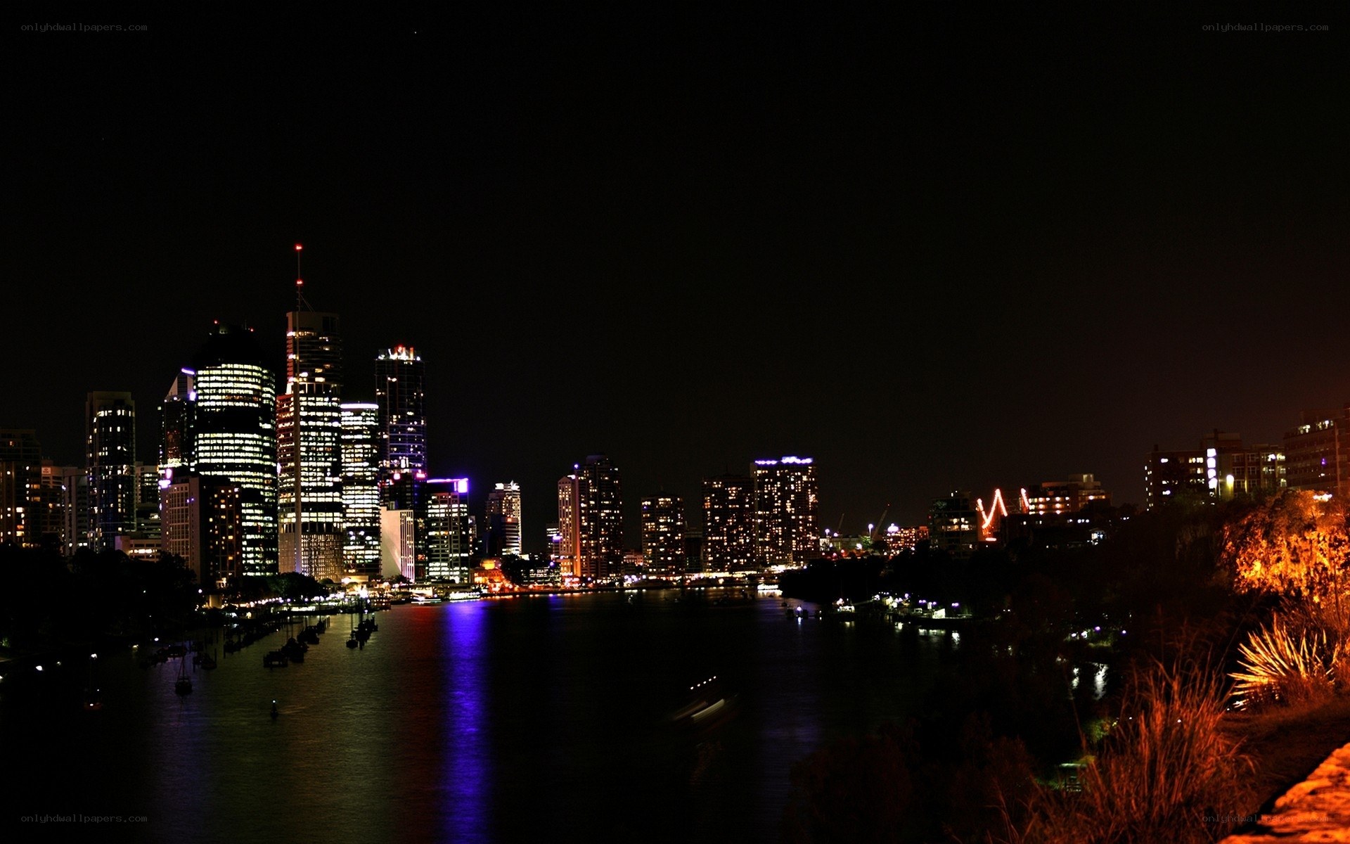 nighttime city skyline by the river