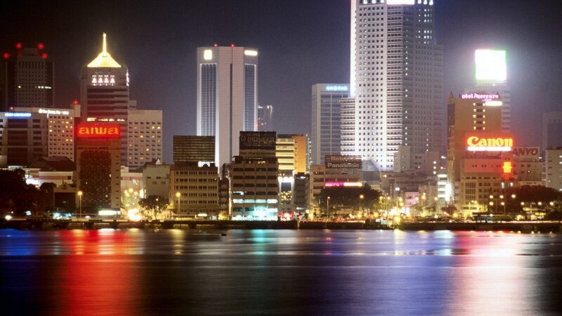 nighttime city skyline by water