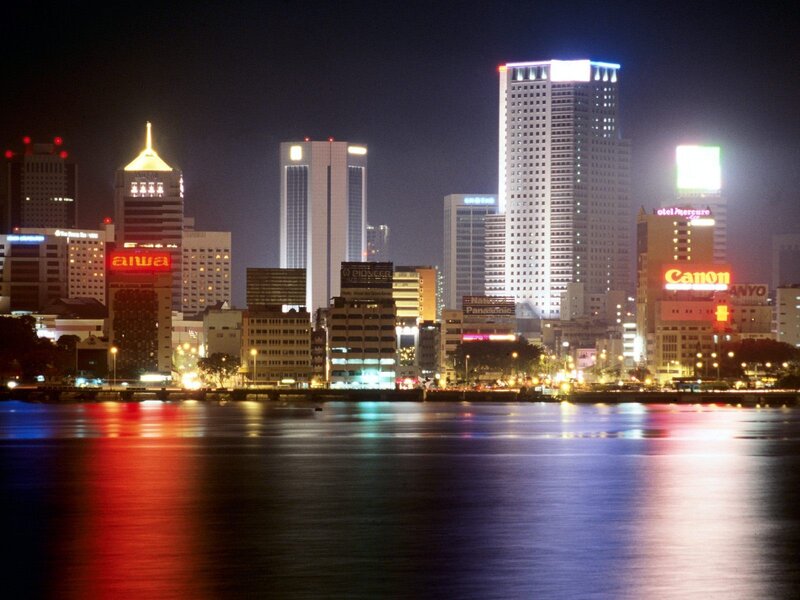 nighttime city skyline by water