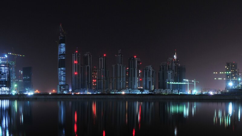 nighttime city skyline by water