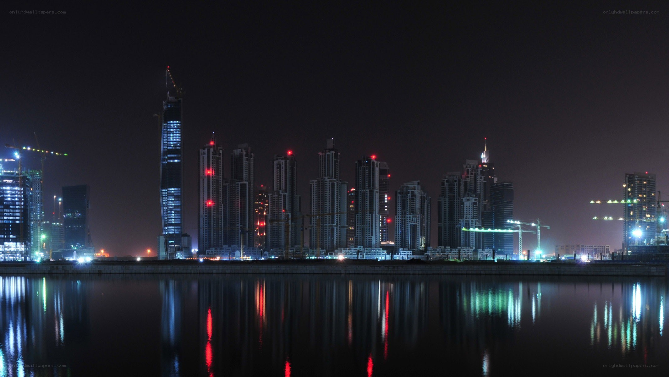 nighttime city skyline by water