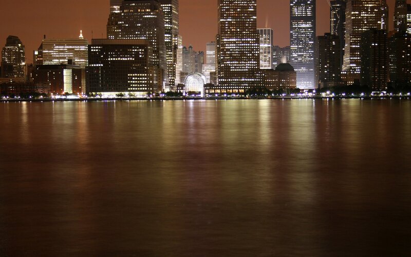 nighttime city skyline by water