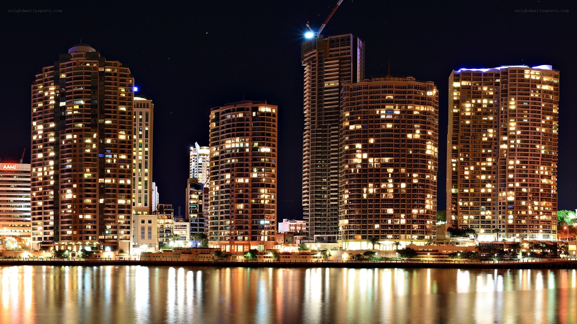 nighttime city skyline by water