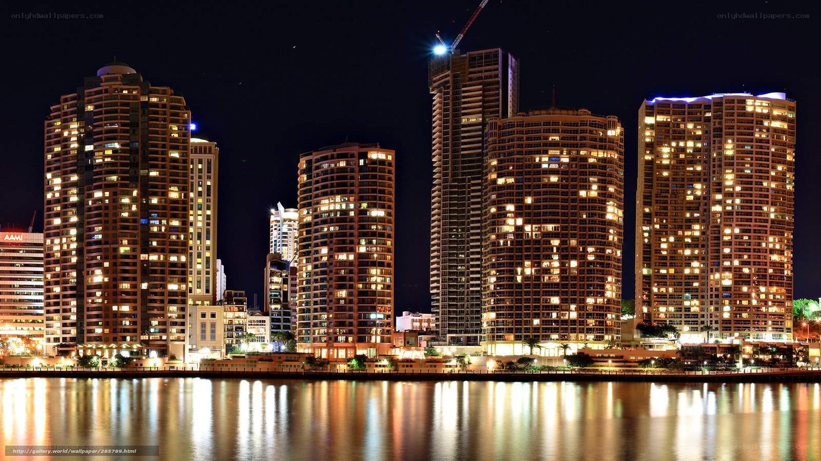 nighttime city skyline by water