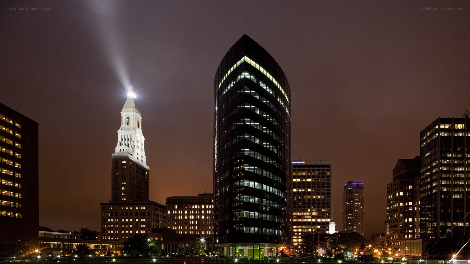 nighttime city skyline with beacon