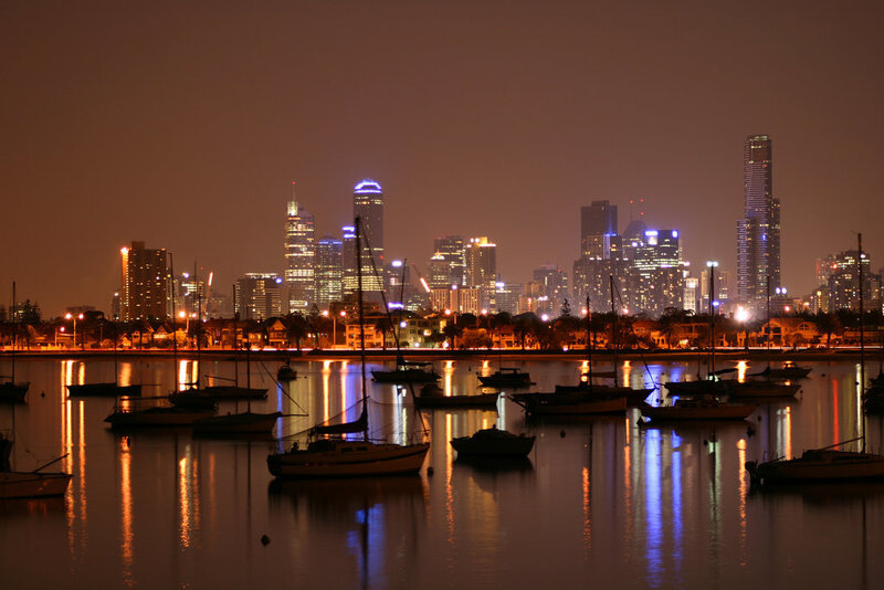 nighttime city skyline with boats