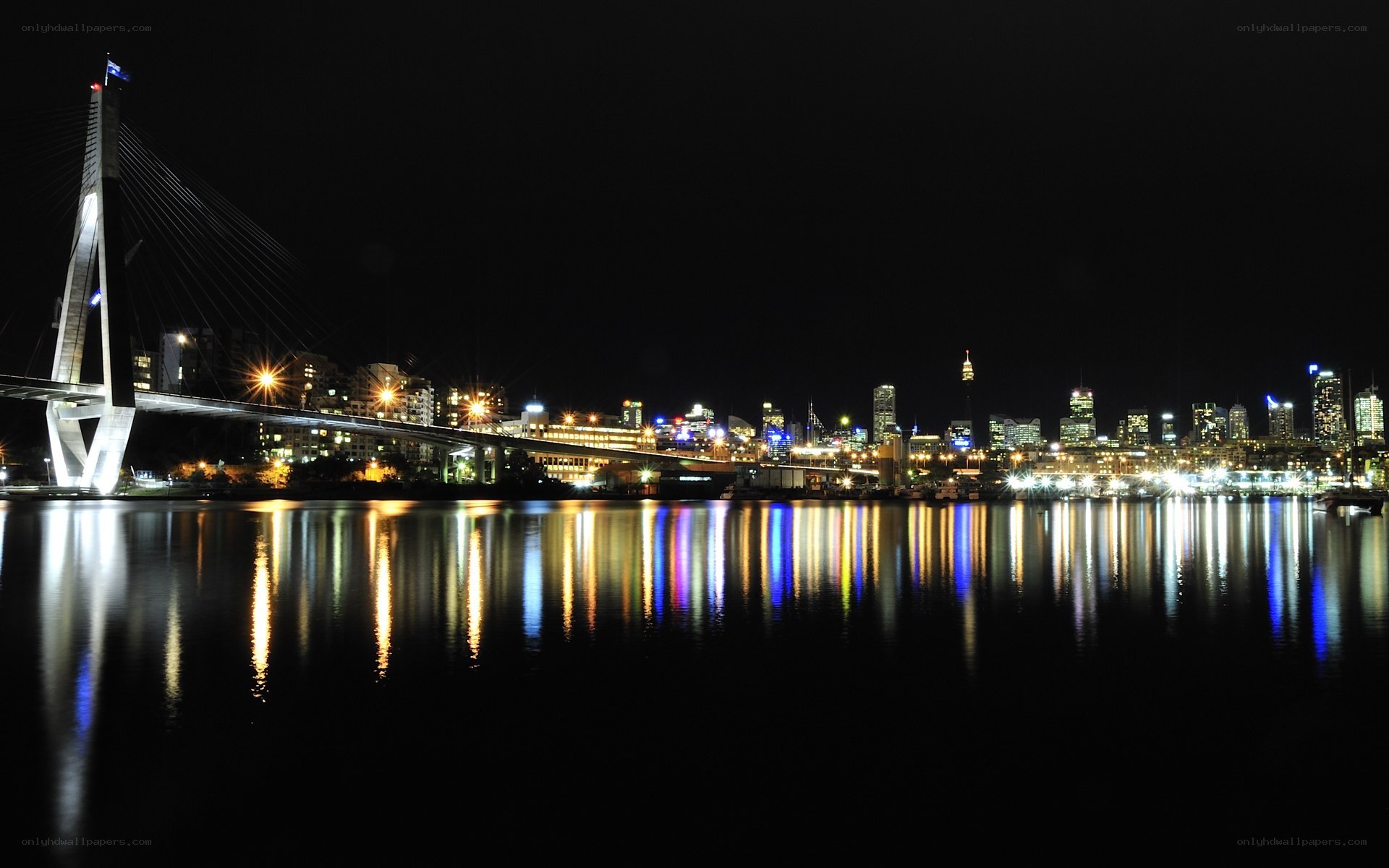nighttime city skyline with bridge