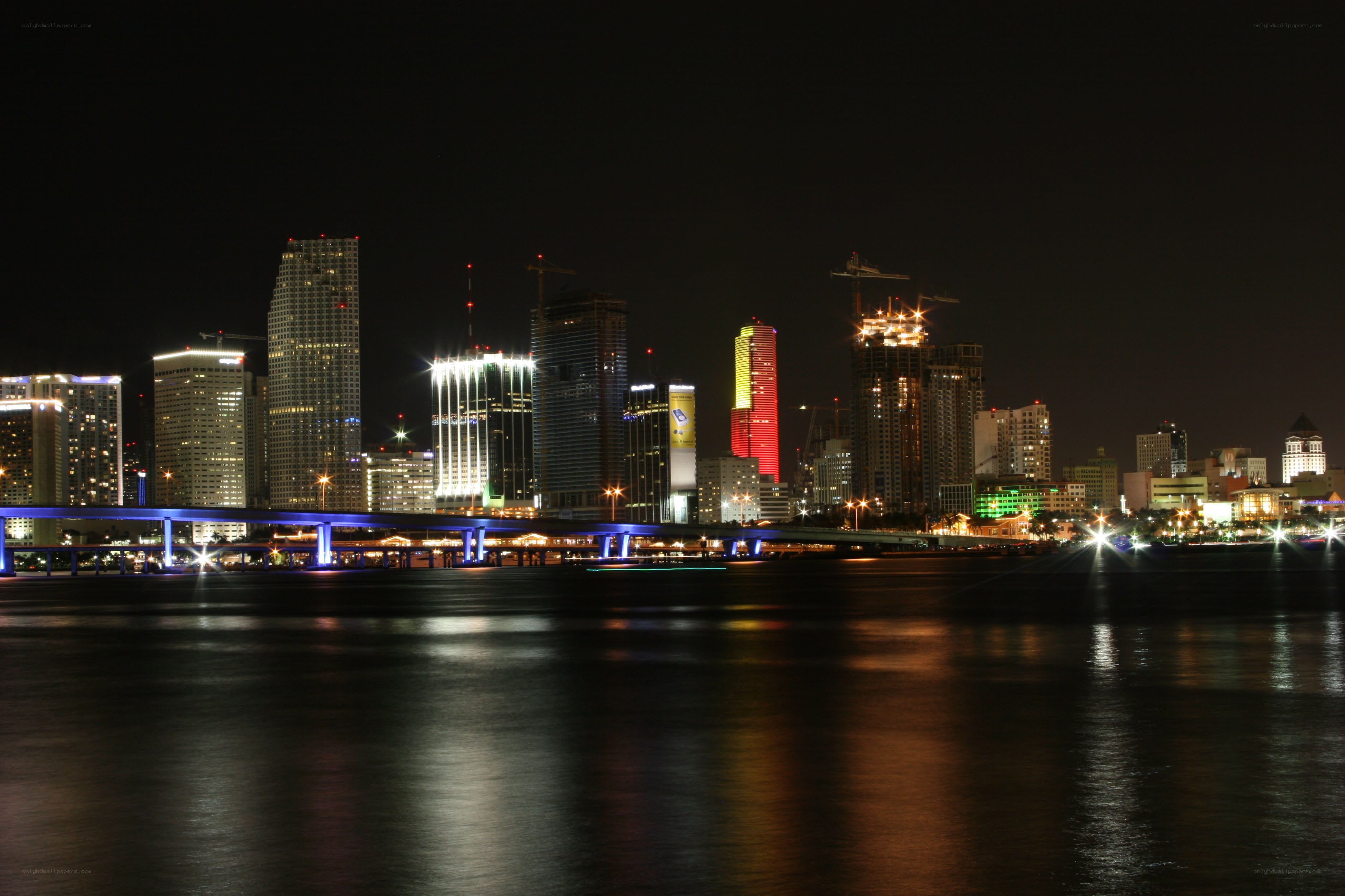 nighttime city skyline with bridge