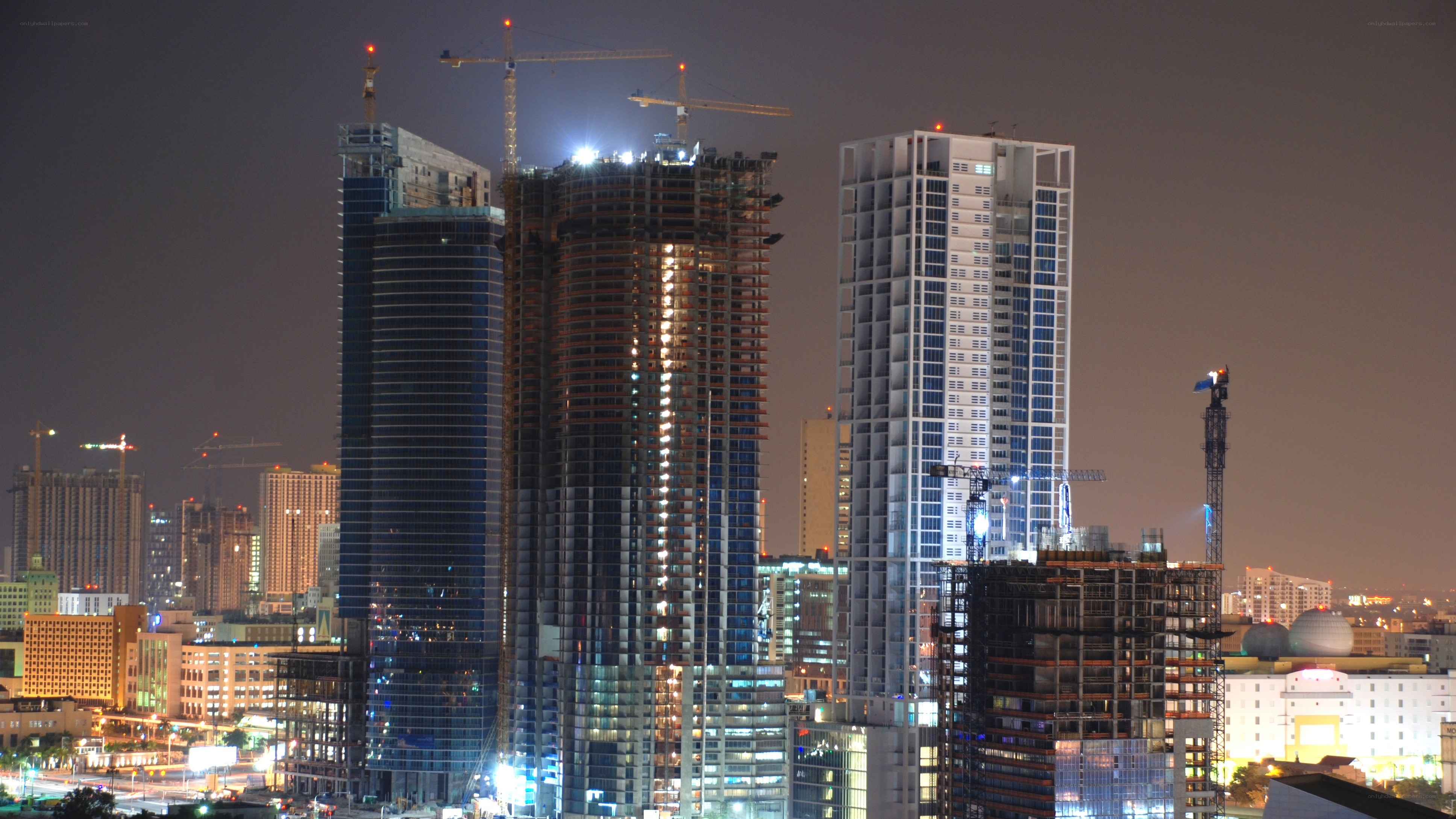 Nighttime city skyline with construction