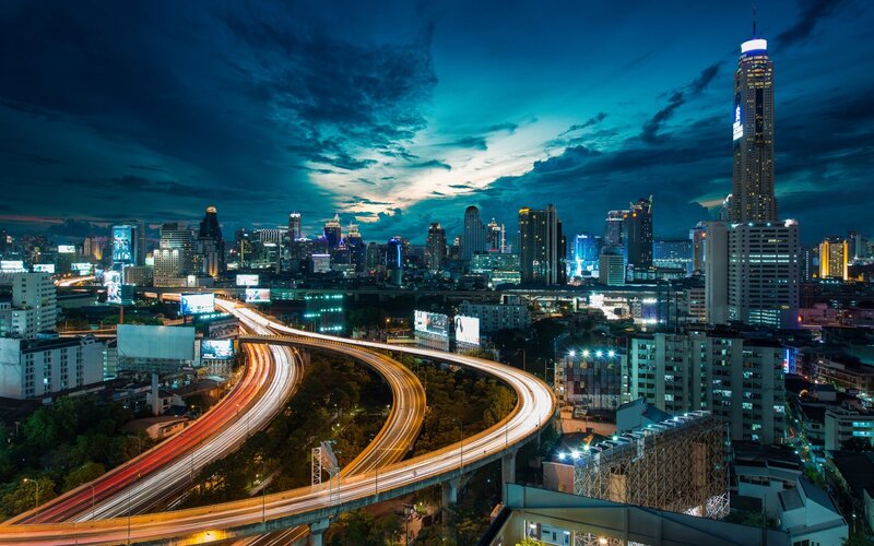 nighttime city skyline with highway