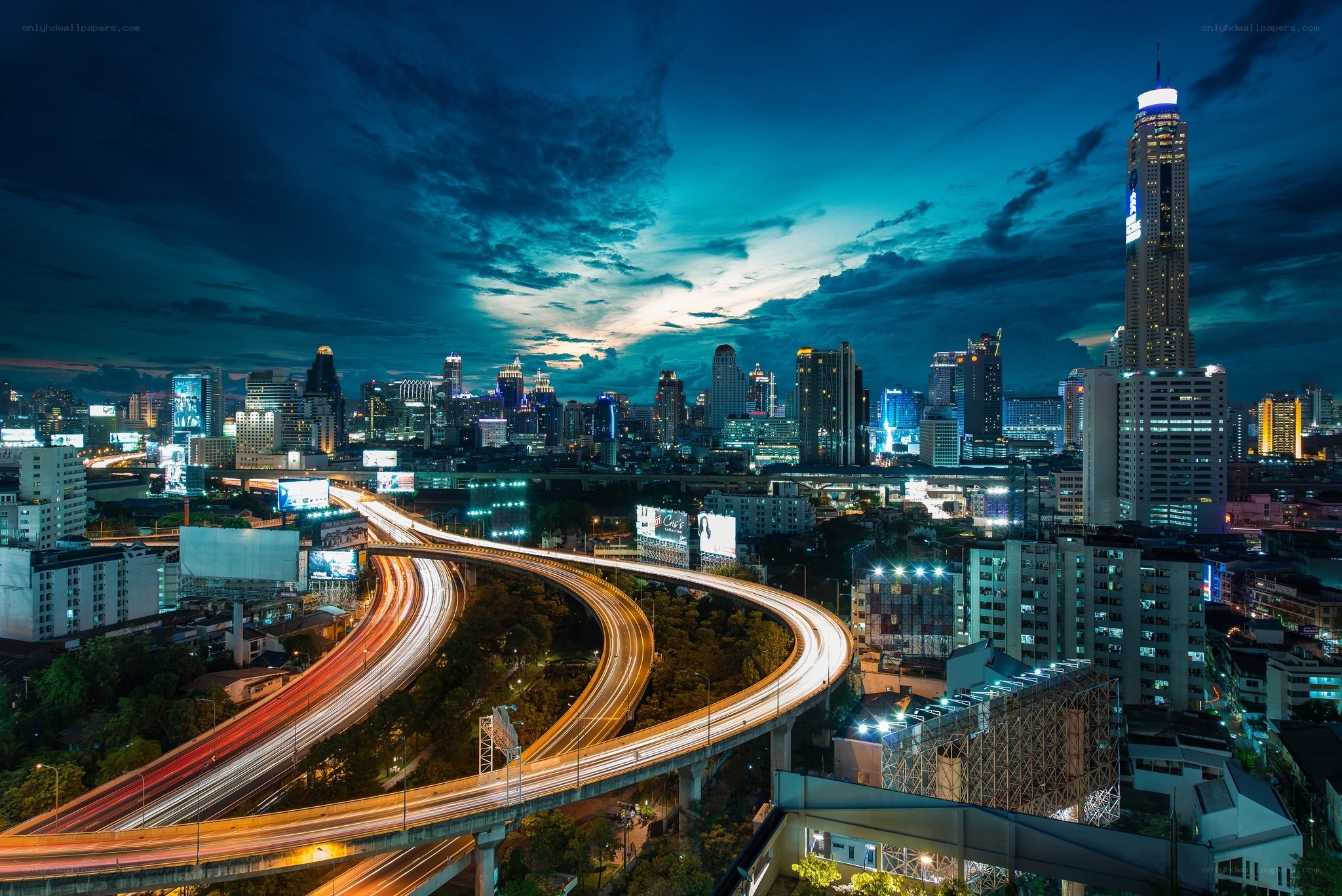 Nighttime city skyline with highways