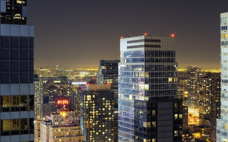 nighttime city skyline with hotel sign