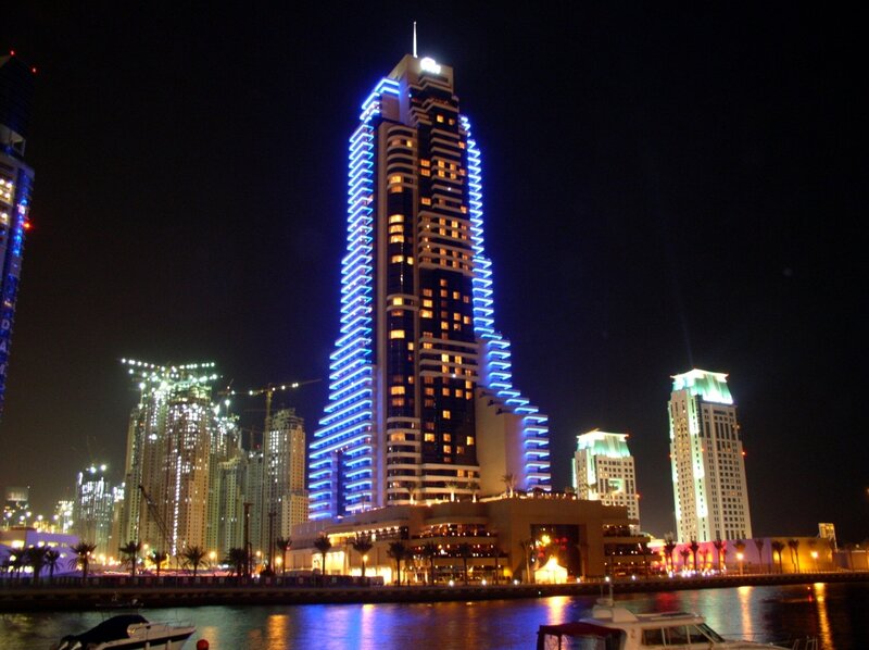 nighttime city skyline with illuminated skyscraper