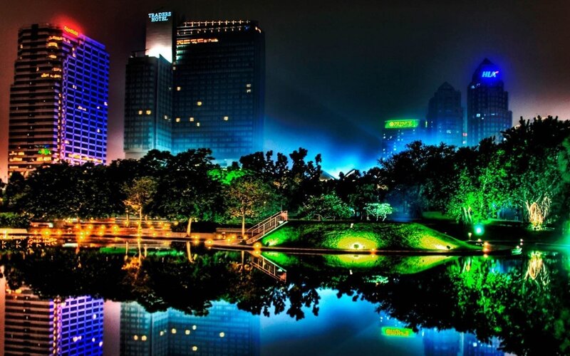 nighttime city skyline with lake
