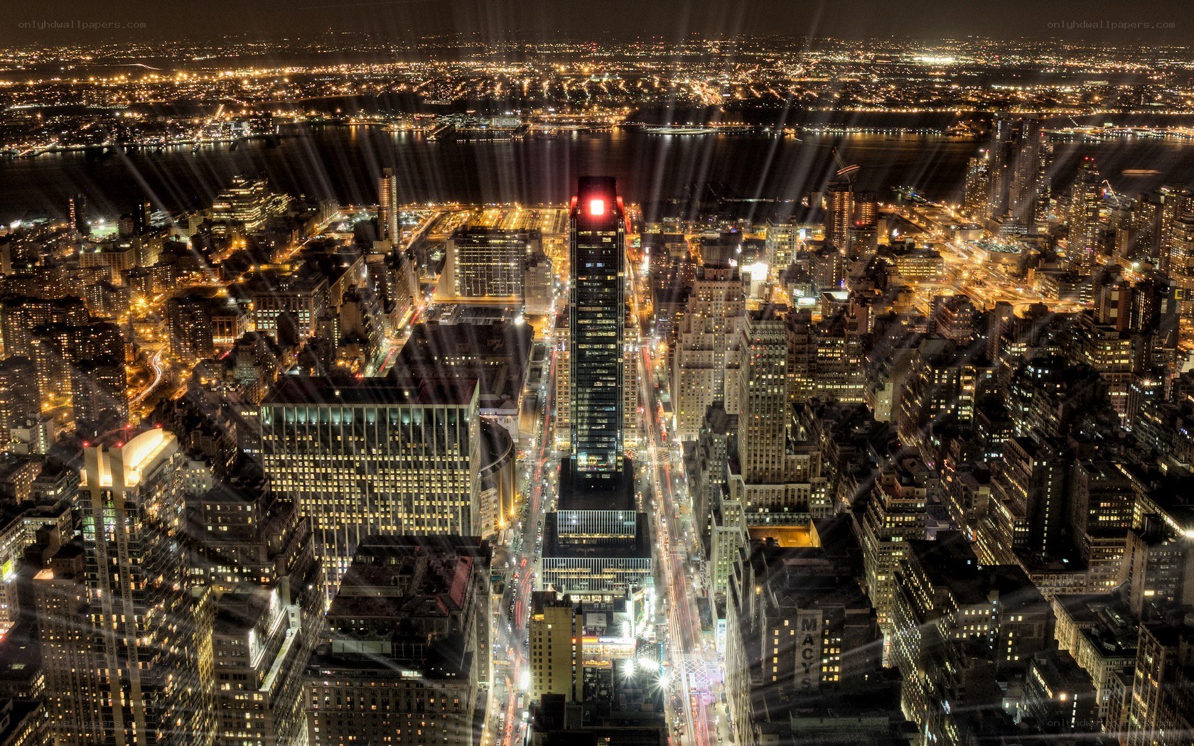 nighttime city skyline with light beams