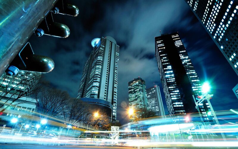 nighttime city skyline with light trails