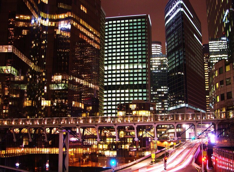 nighttime city skyline with light trails