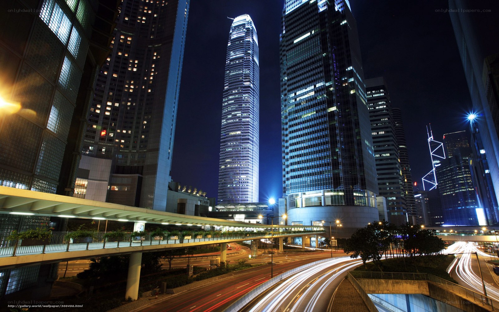 Nighttime city skyline with light trails