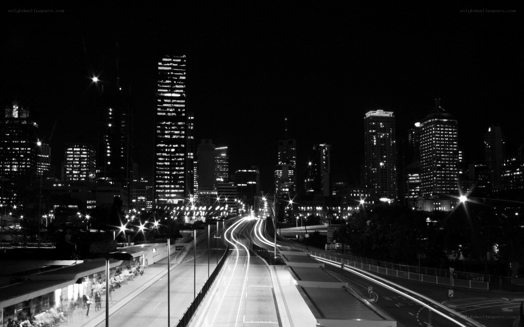 Nighttime city skyline with light trails