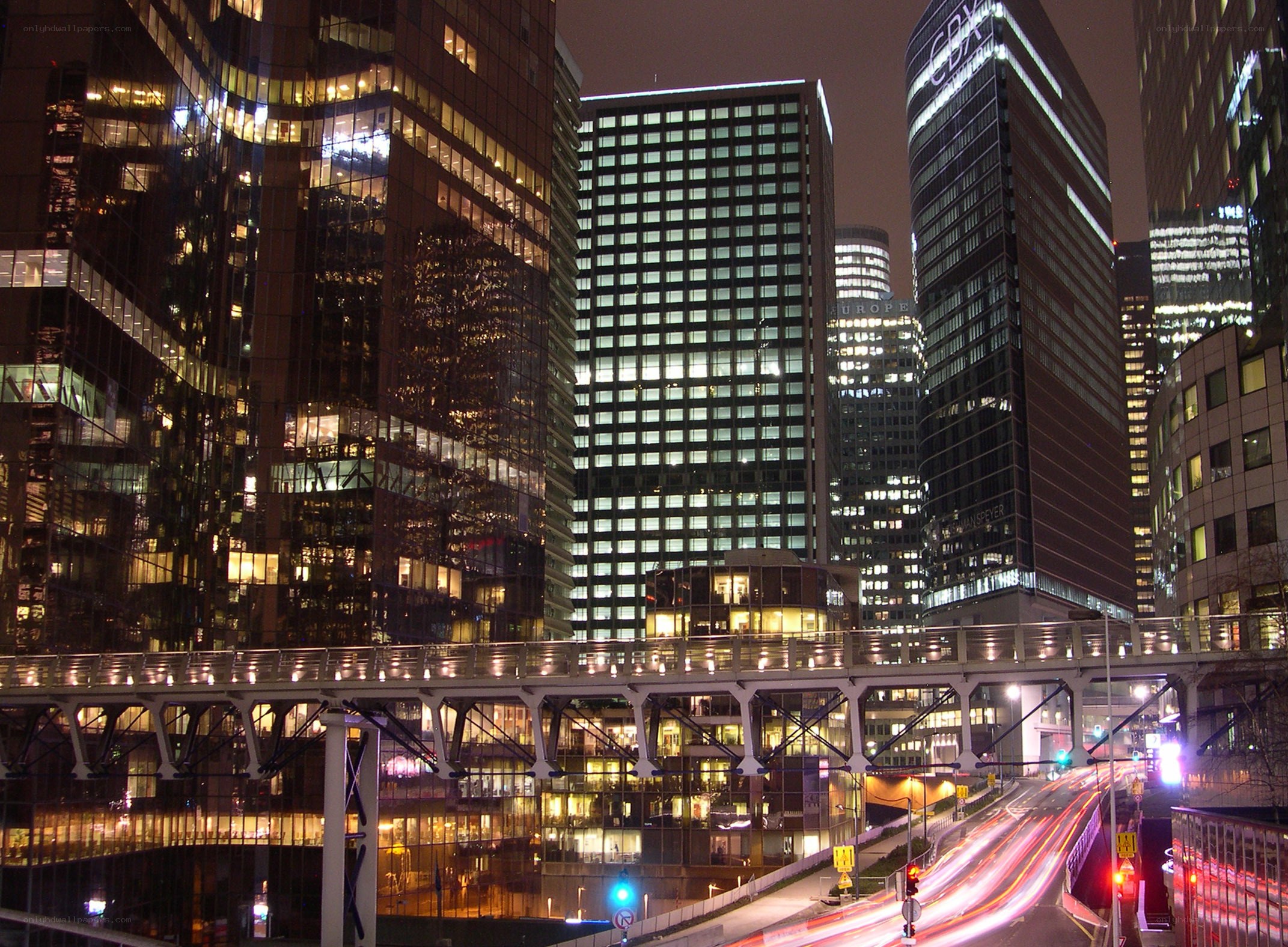 nighttime city skyline with light trails