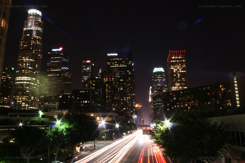 nighttime city skyline with light trails