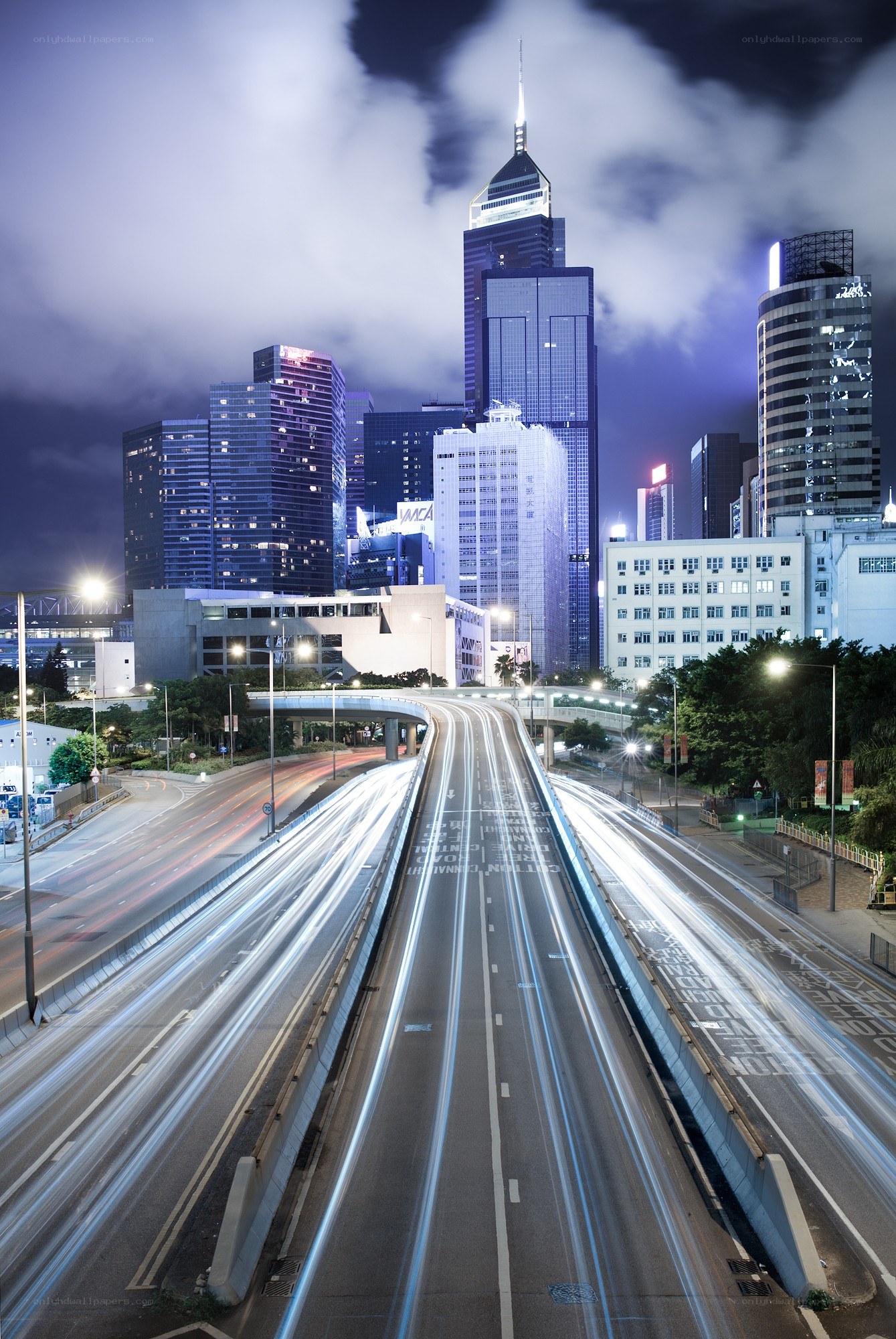 Nighttime city skyline with light trails