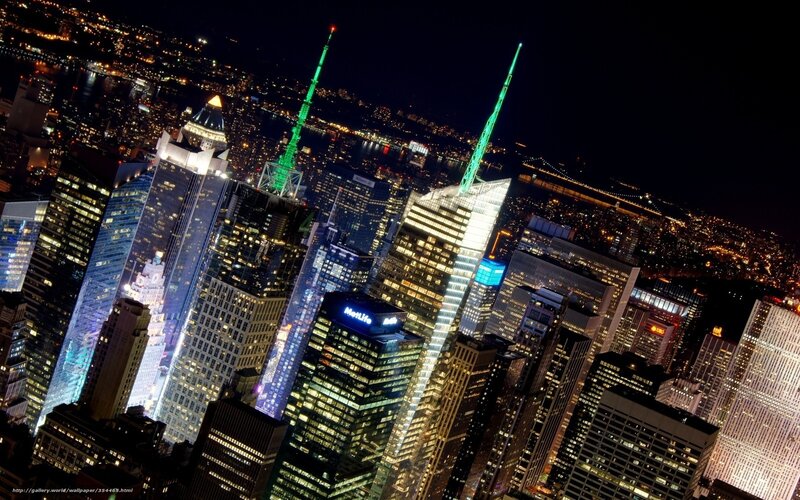 Nighttime city skyline with lit skyscrapers