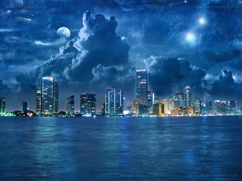 nighttime city skyline with moon