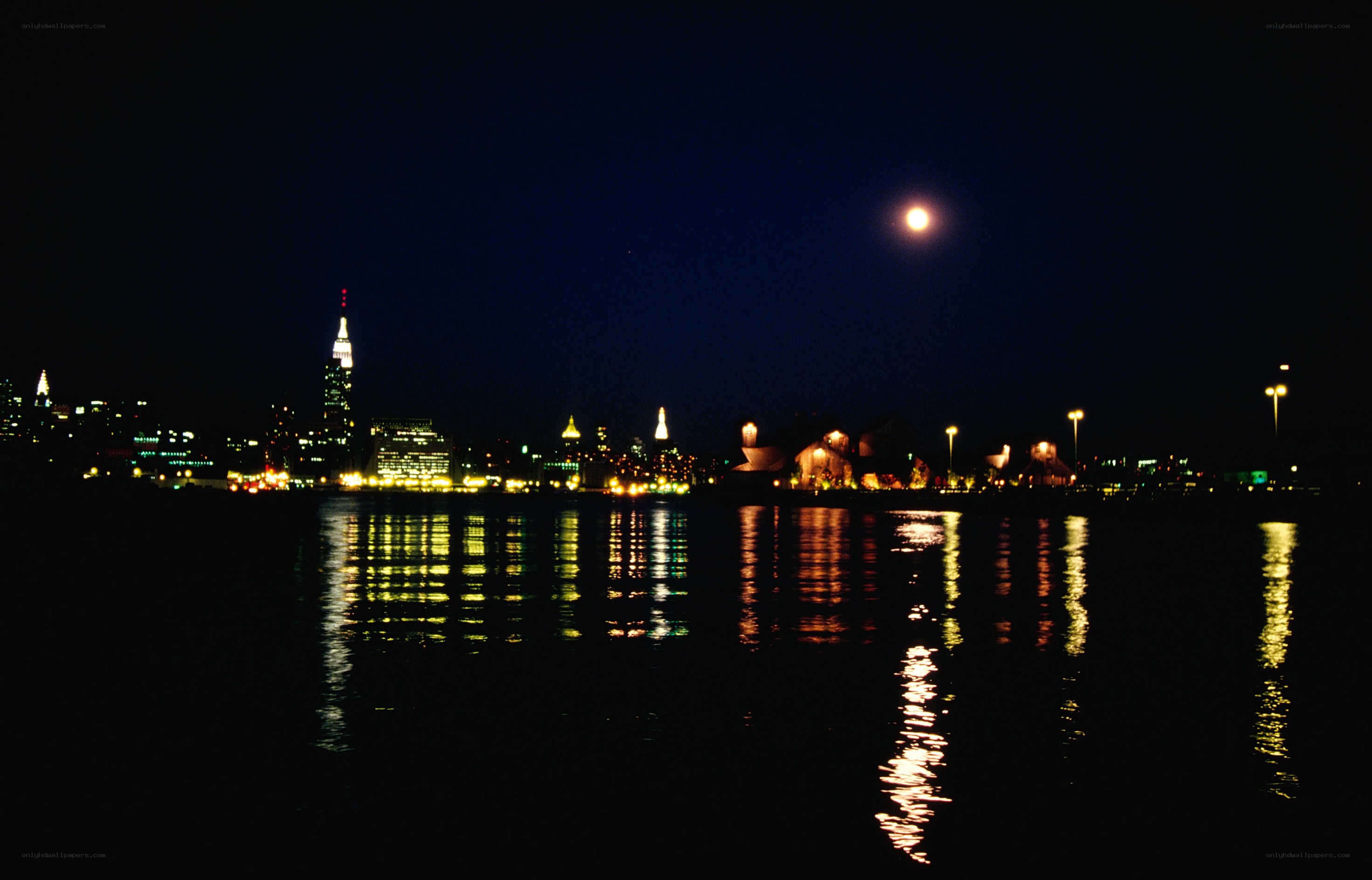 nighttime city skyline with moon