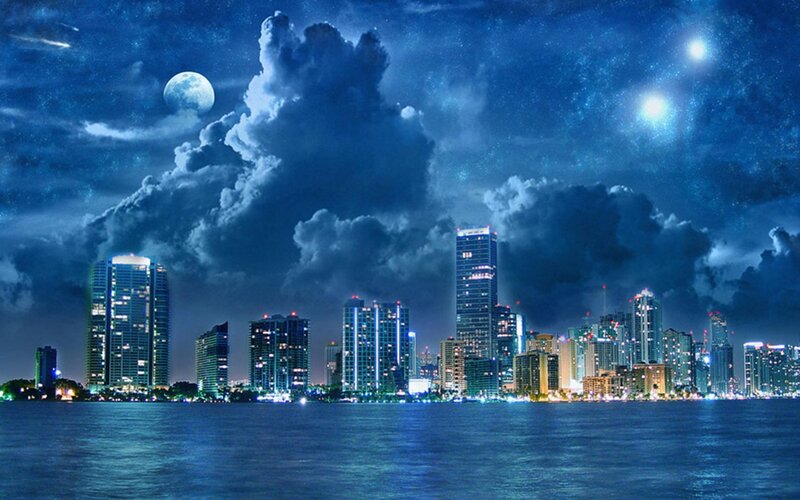 nighttime city skyline with moon