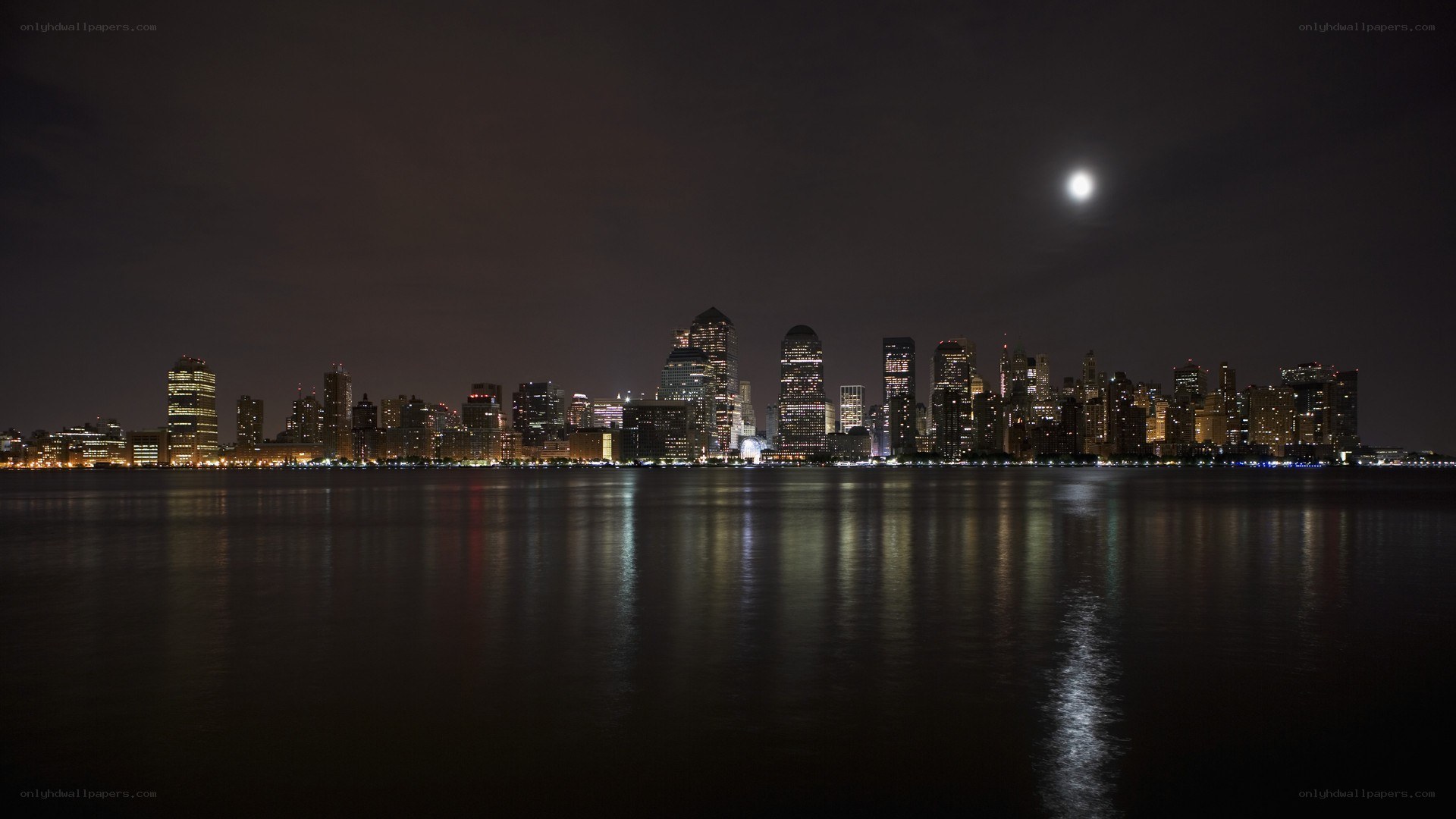 nighttime city skyline with moon