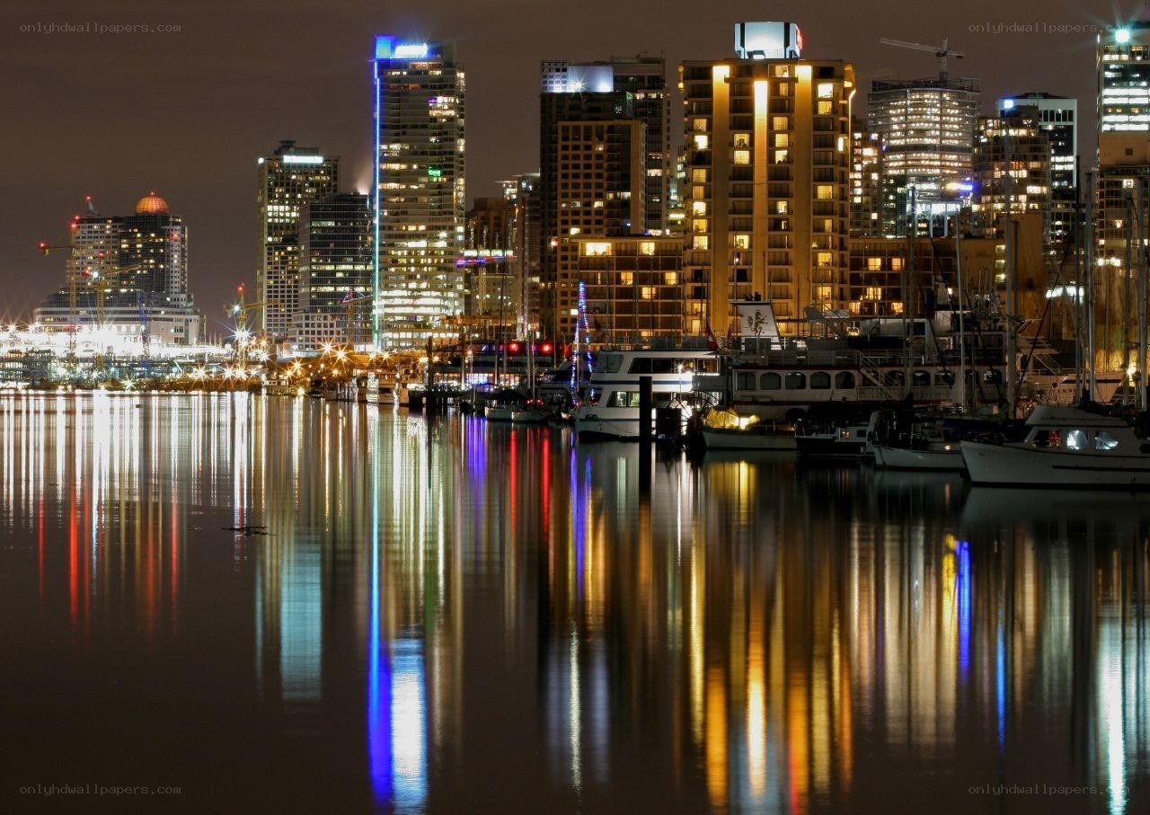 nighttime city skyline with reflections