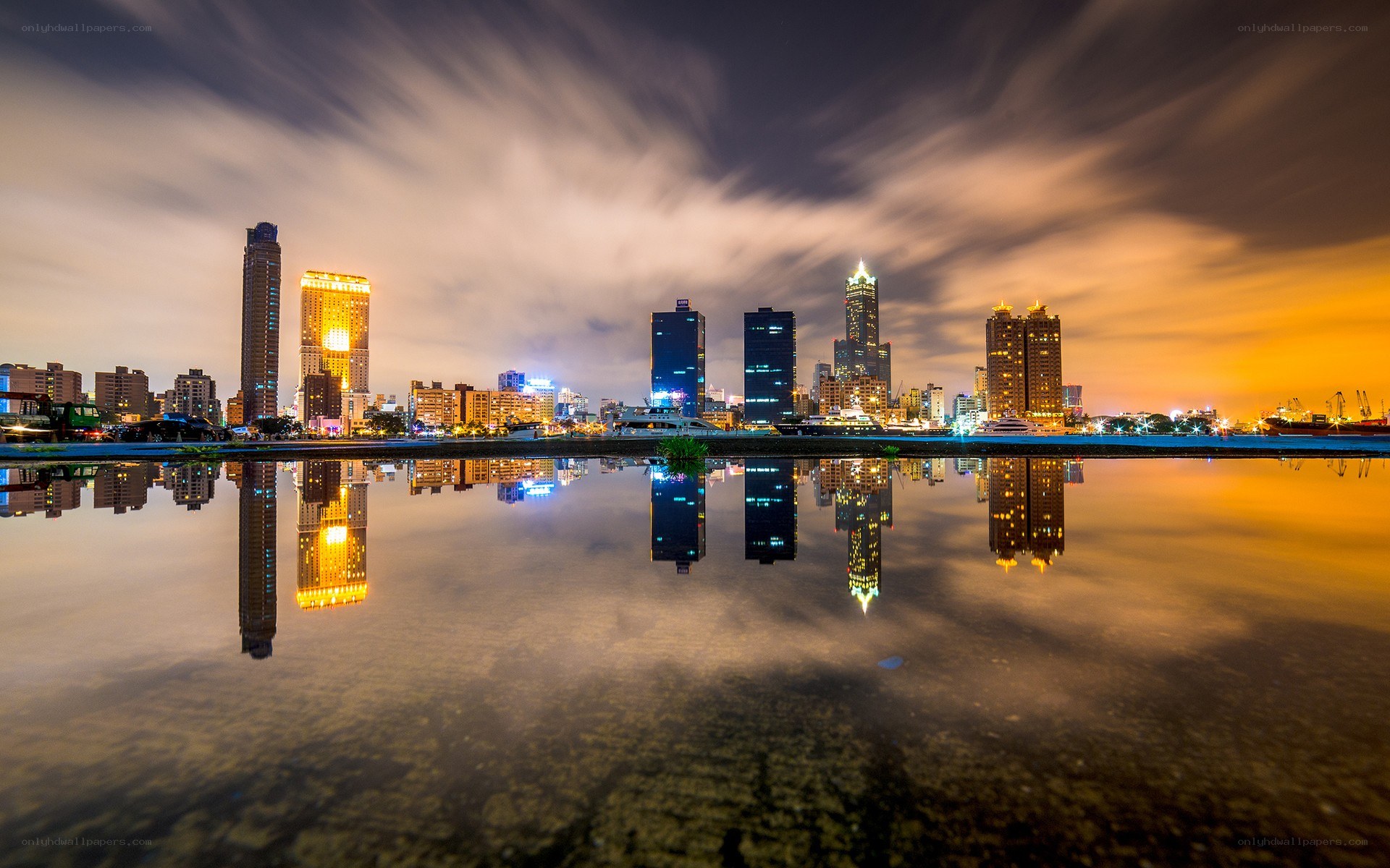 Nighttime city skyline with reflections