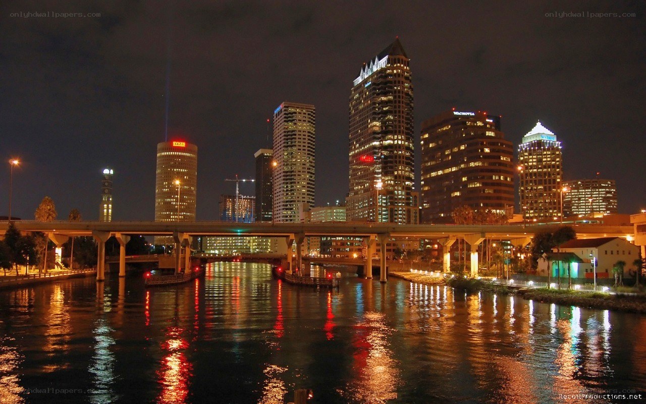 nighttime city skyline with river