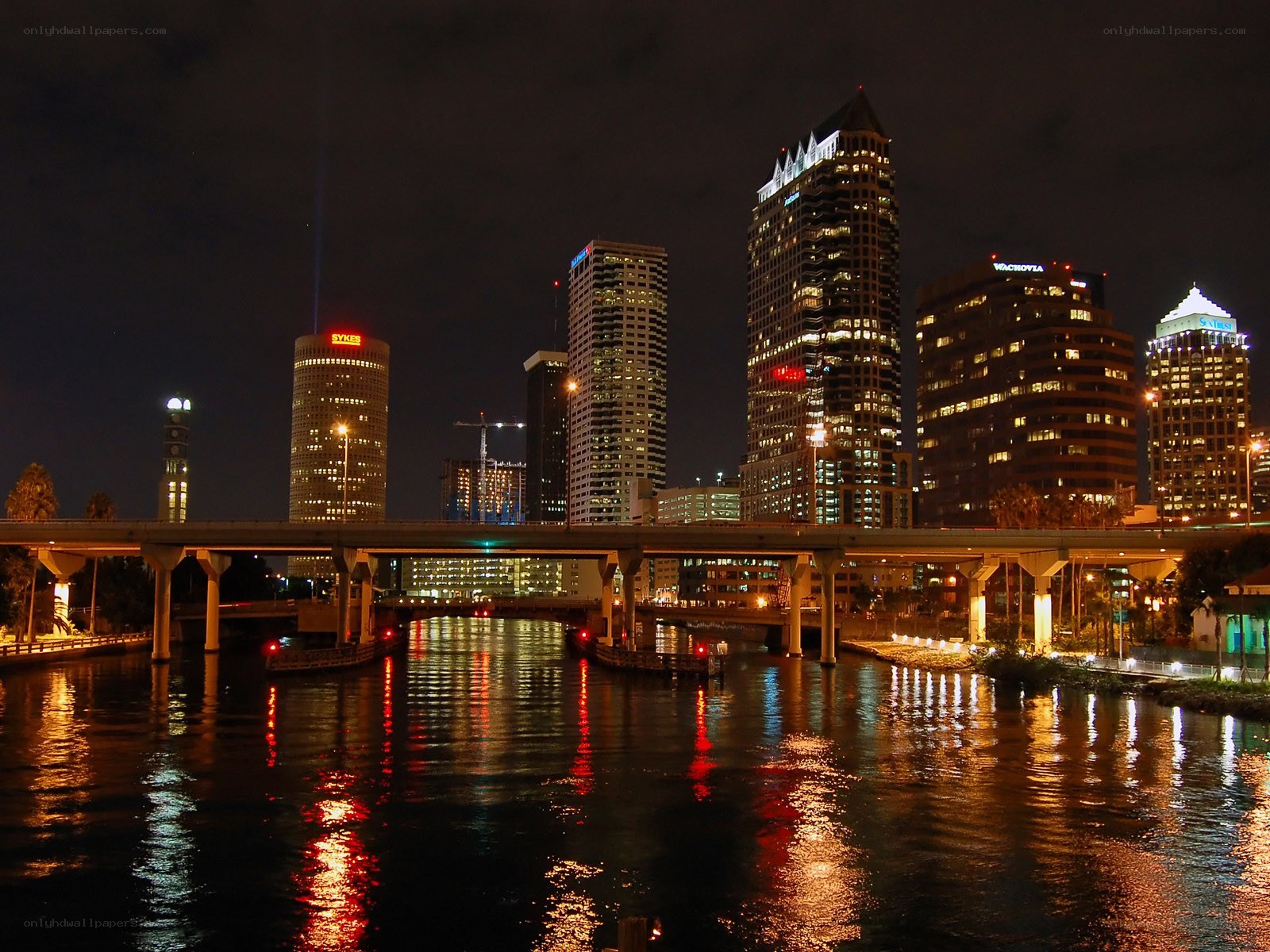 nighttime city skyline with river