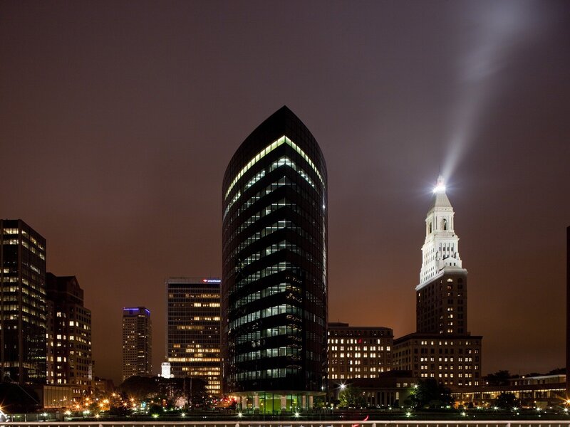 Nighttime city skyline with tower