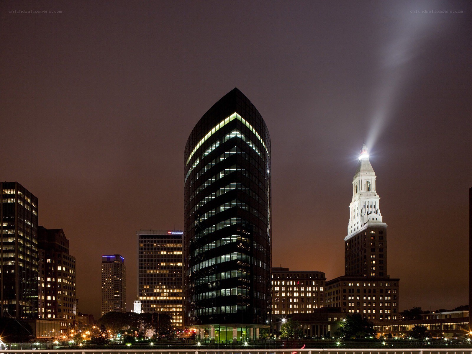 Nighttime city skyline with tower