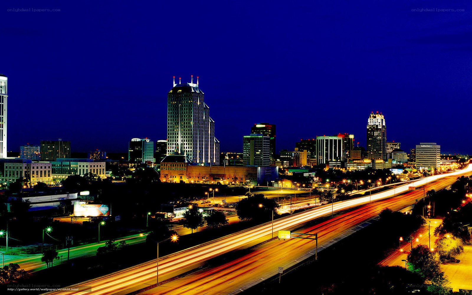 Nighttime city skyline with traffic