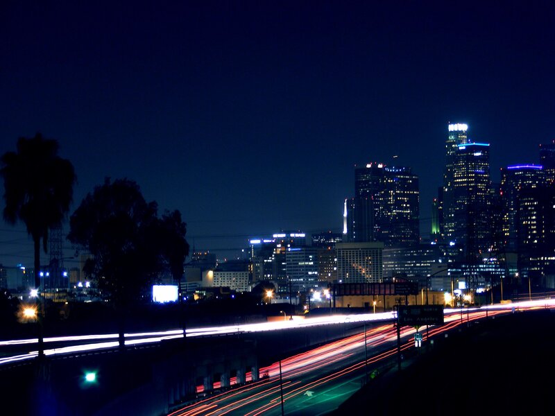 nighttime city skyline with traffic