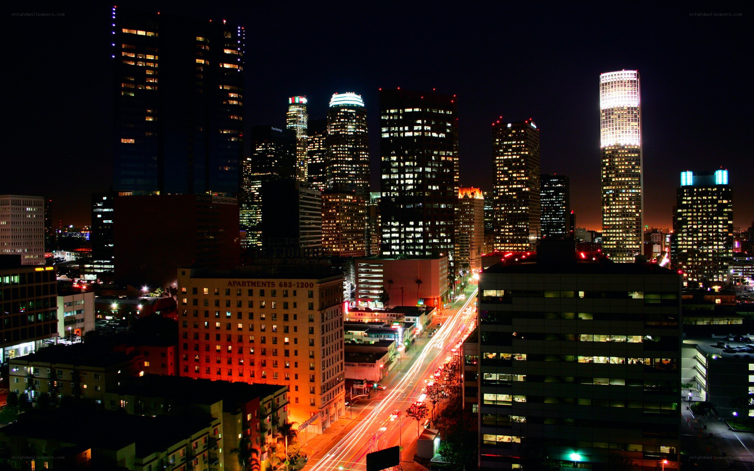 nighttime city skyline with traffic