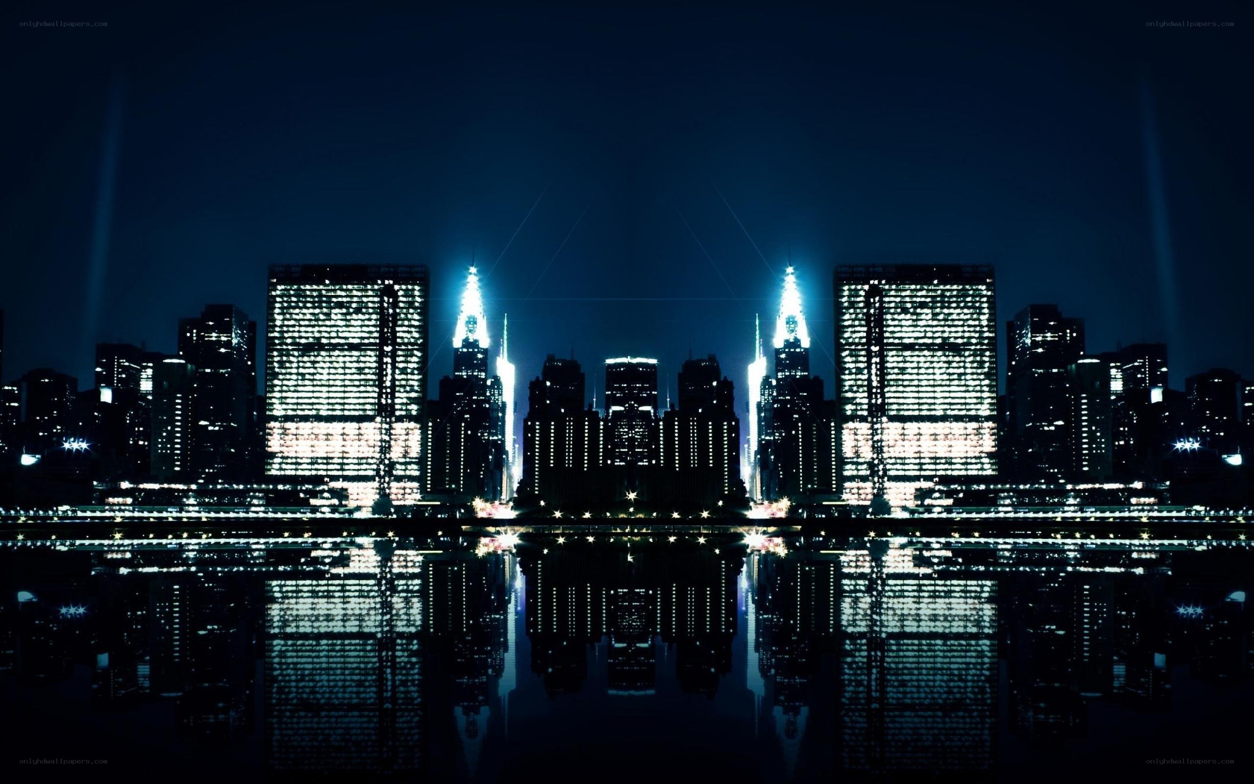 nighttime city skyline with water reflection