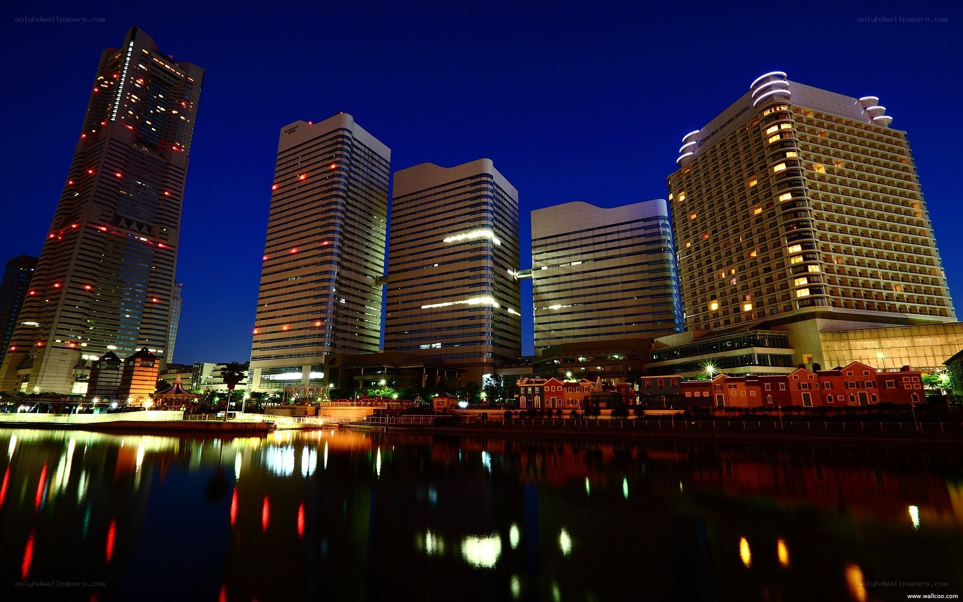 nighttime city skyline with water reflection