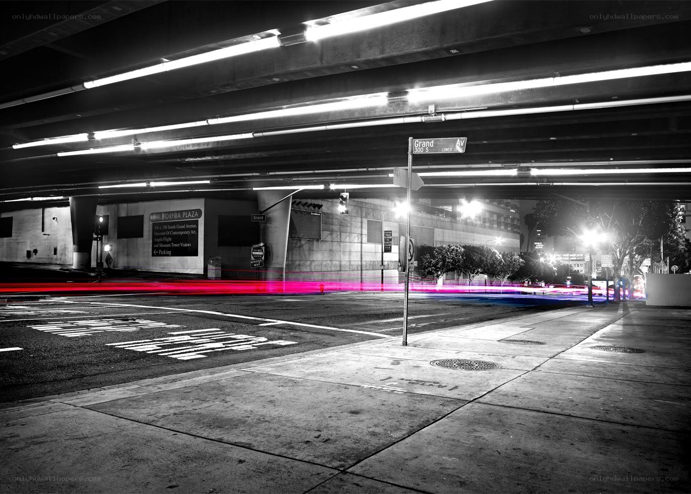 Nighttime city street under overpass