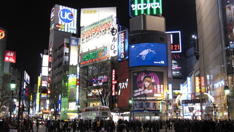 nighttime city street with billboards