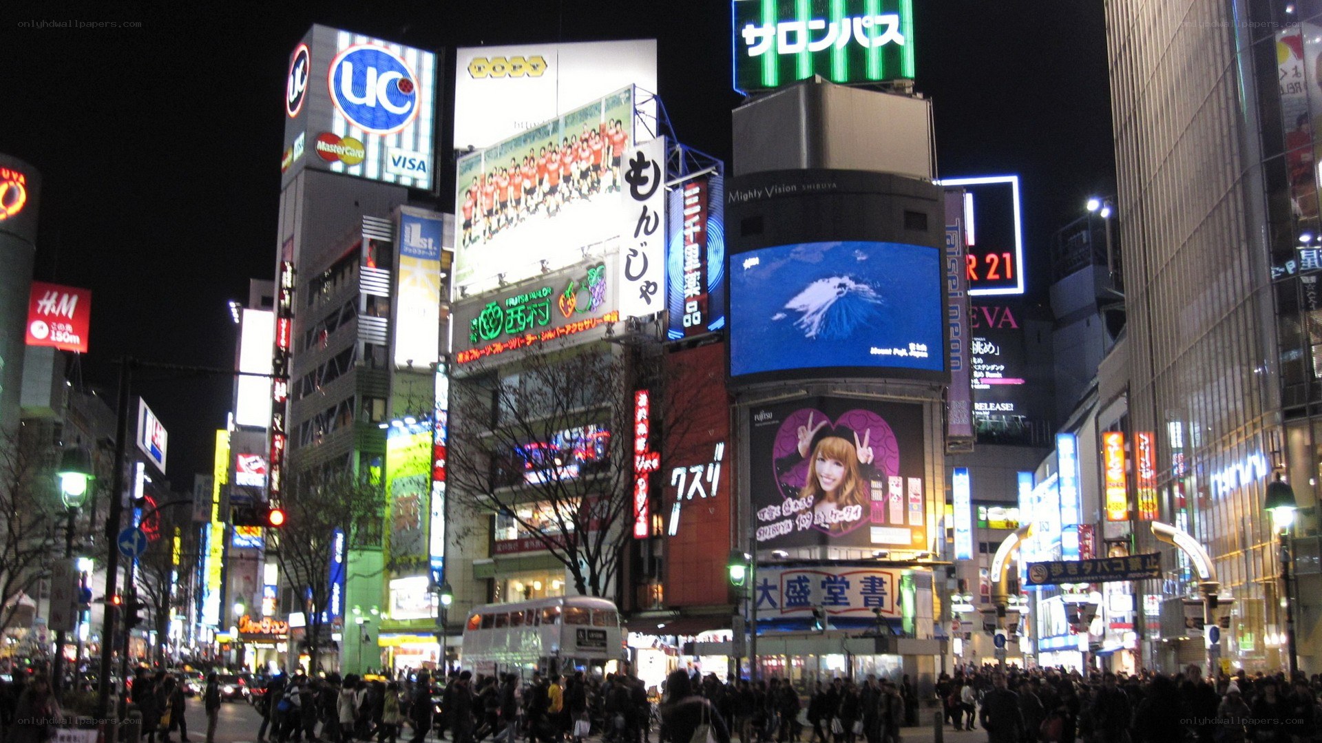 nighttime city street with billboards