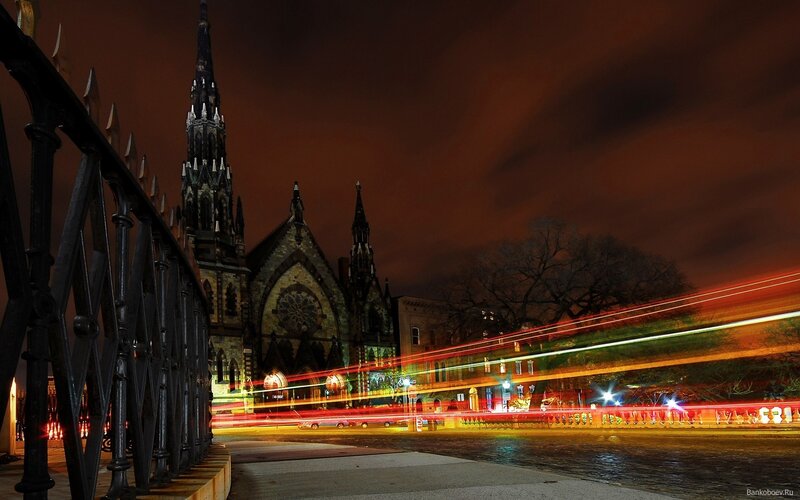 Nighttime city street with church