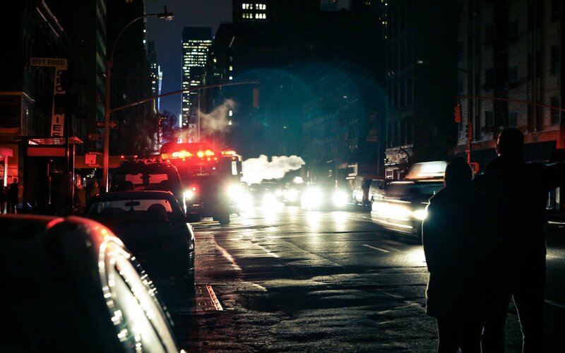 Nighttime city street with emergency vehicles