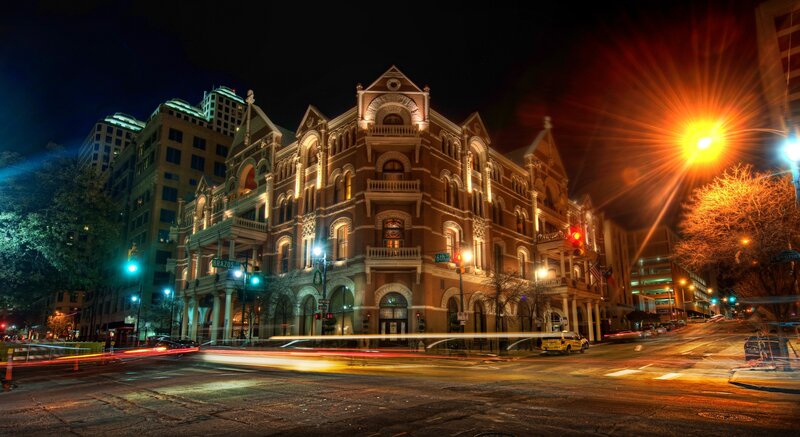 nighttime city street with historic building